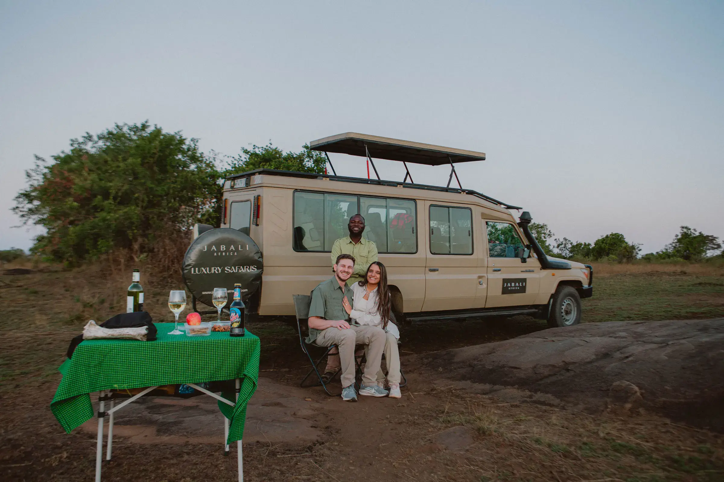 Guests and their guide beside a private Jabali Land Cruiser on the plains