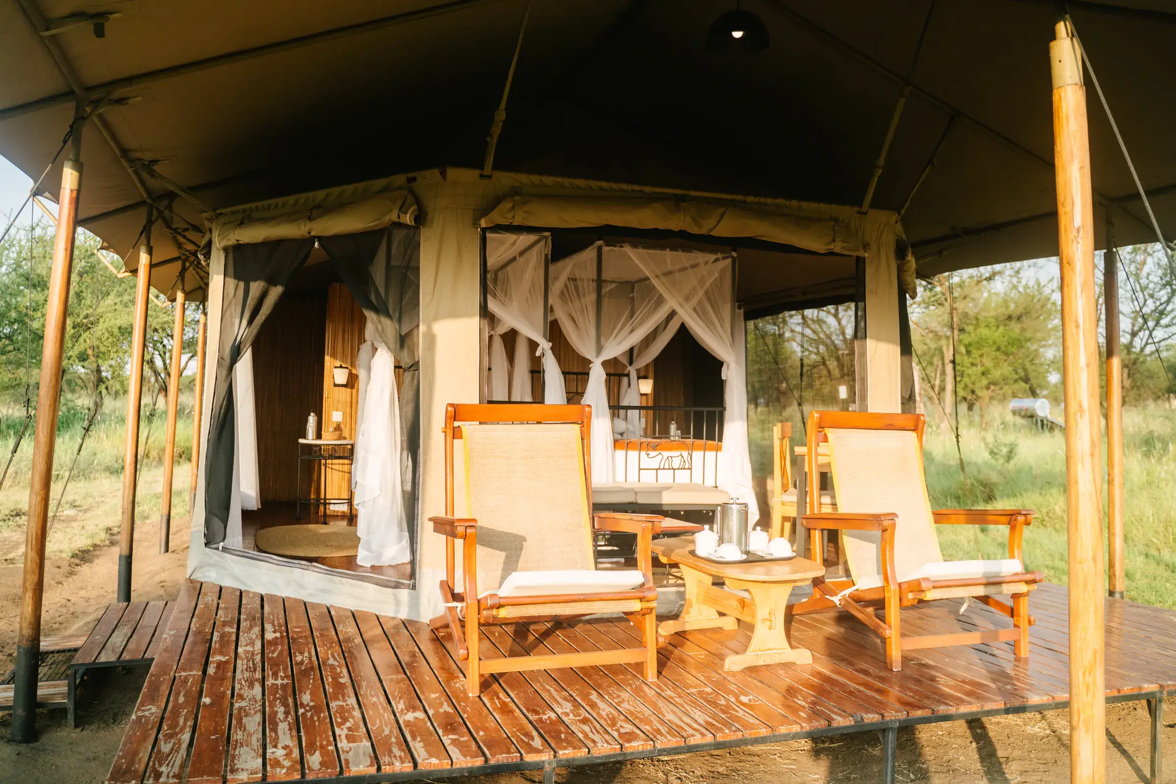 Tented suite veranda with armchairs on a wooden deck